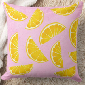 Pillow with orange juice slices on pink background